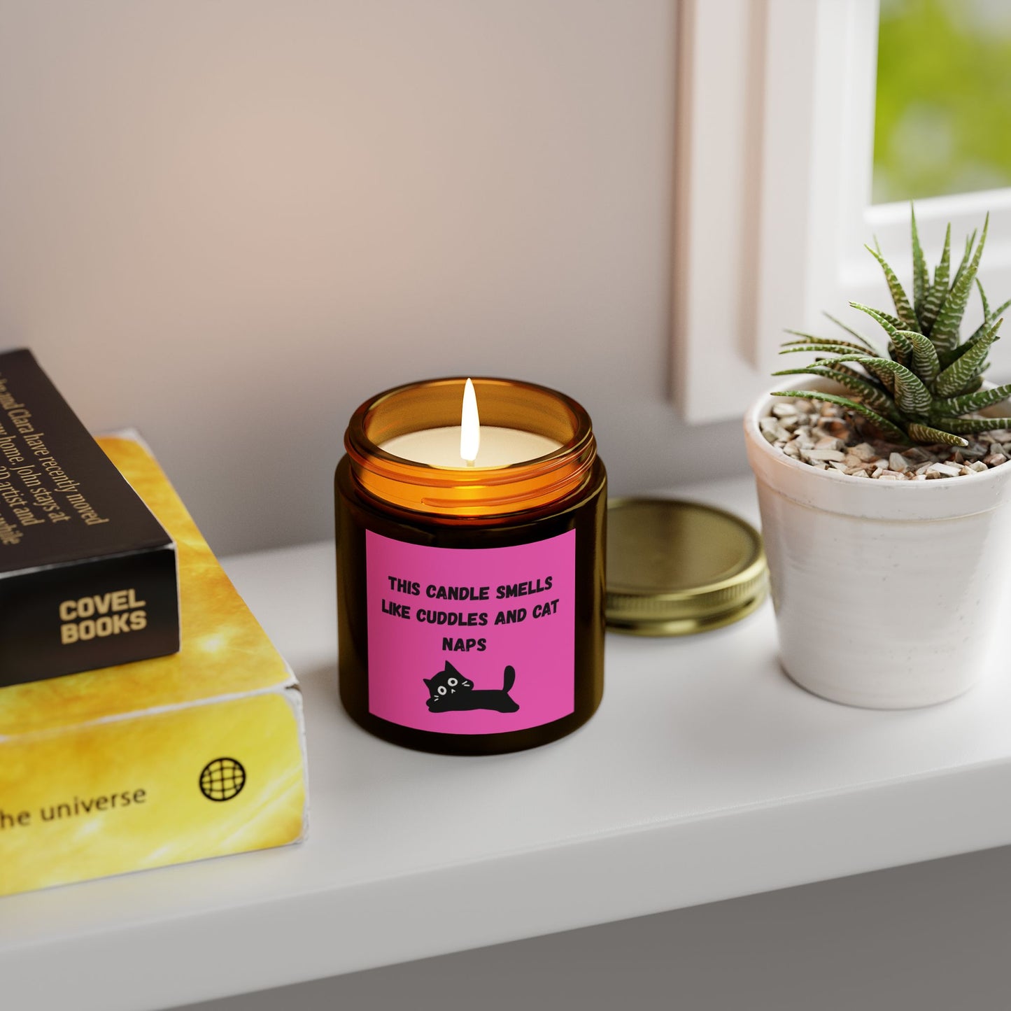 pink labelled candle with cuddles and cat nap text