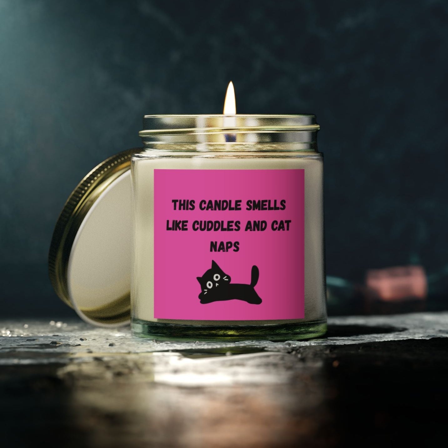 pink labelled candle with cuddles and cat nap text