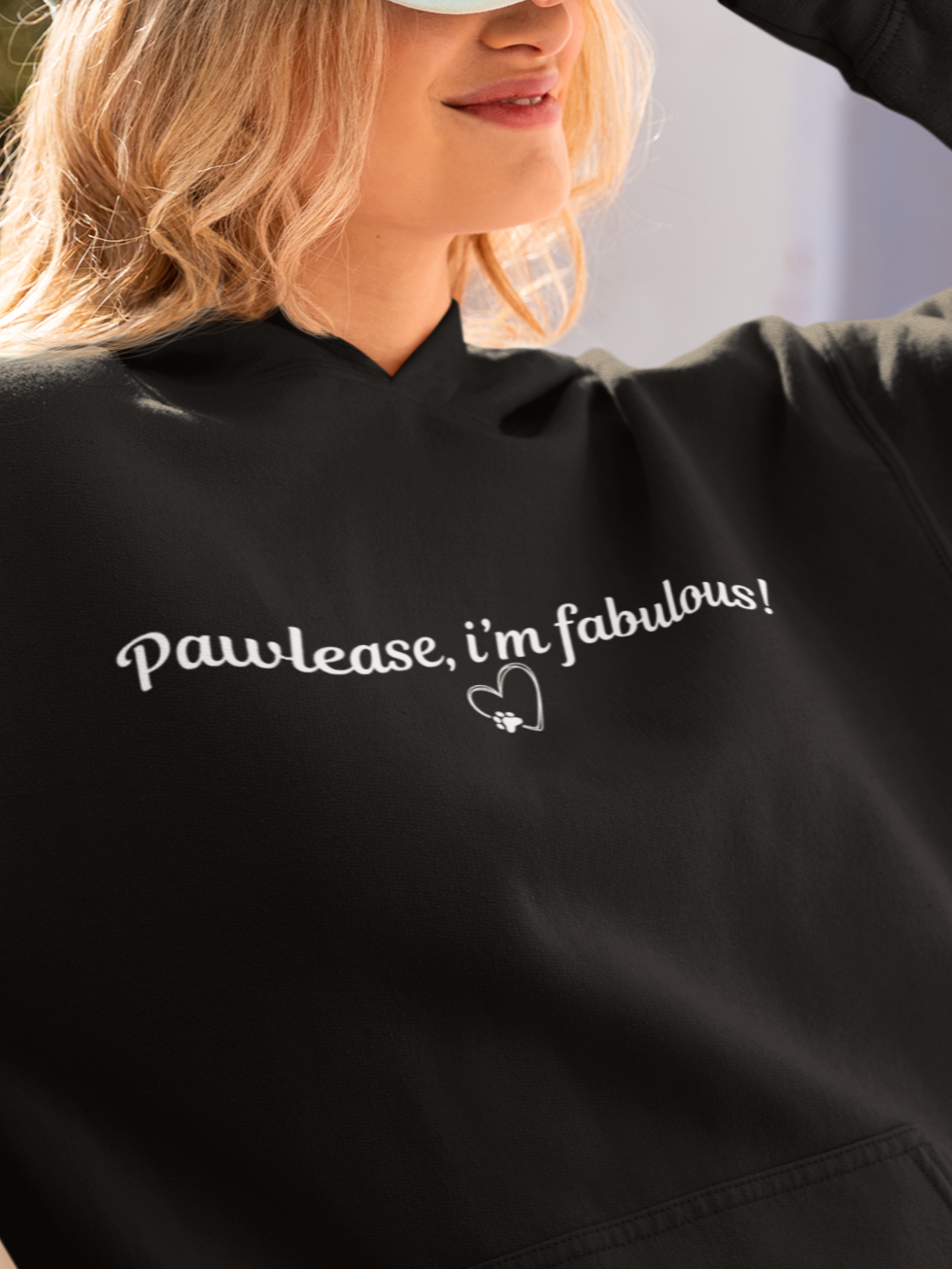 Person wearing a black hoodie with 'Pawlease, I'm fabulous!' text, standing outdoors.