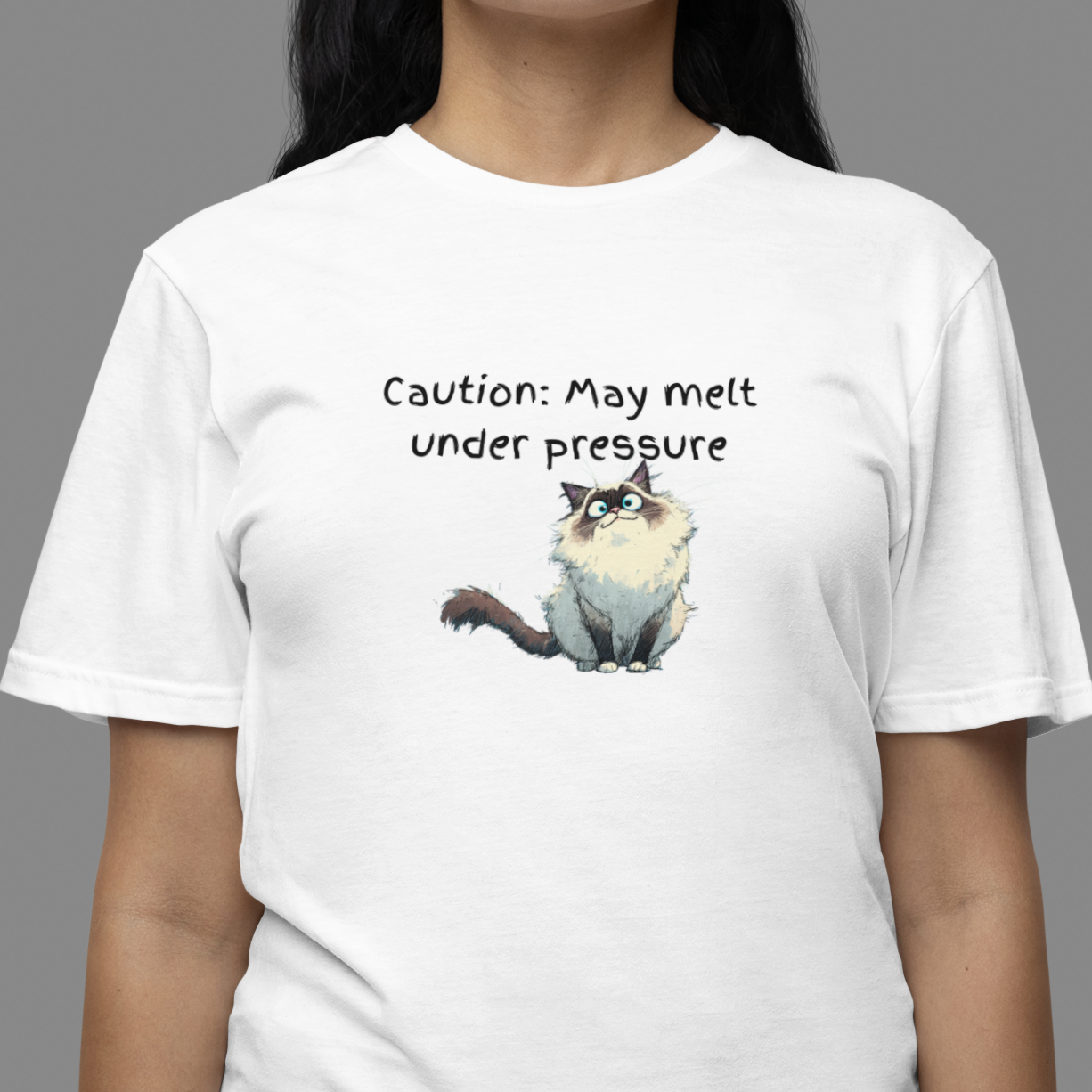 Person wearing a white t-shirt with a cartoon cat and text on a gray background