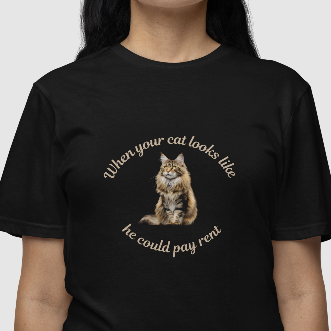 Black t-shirt with a cat graphic and text worn by a person on a white background