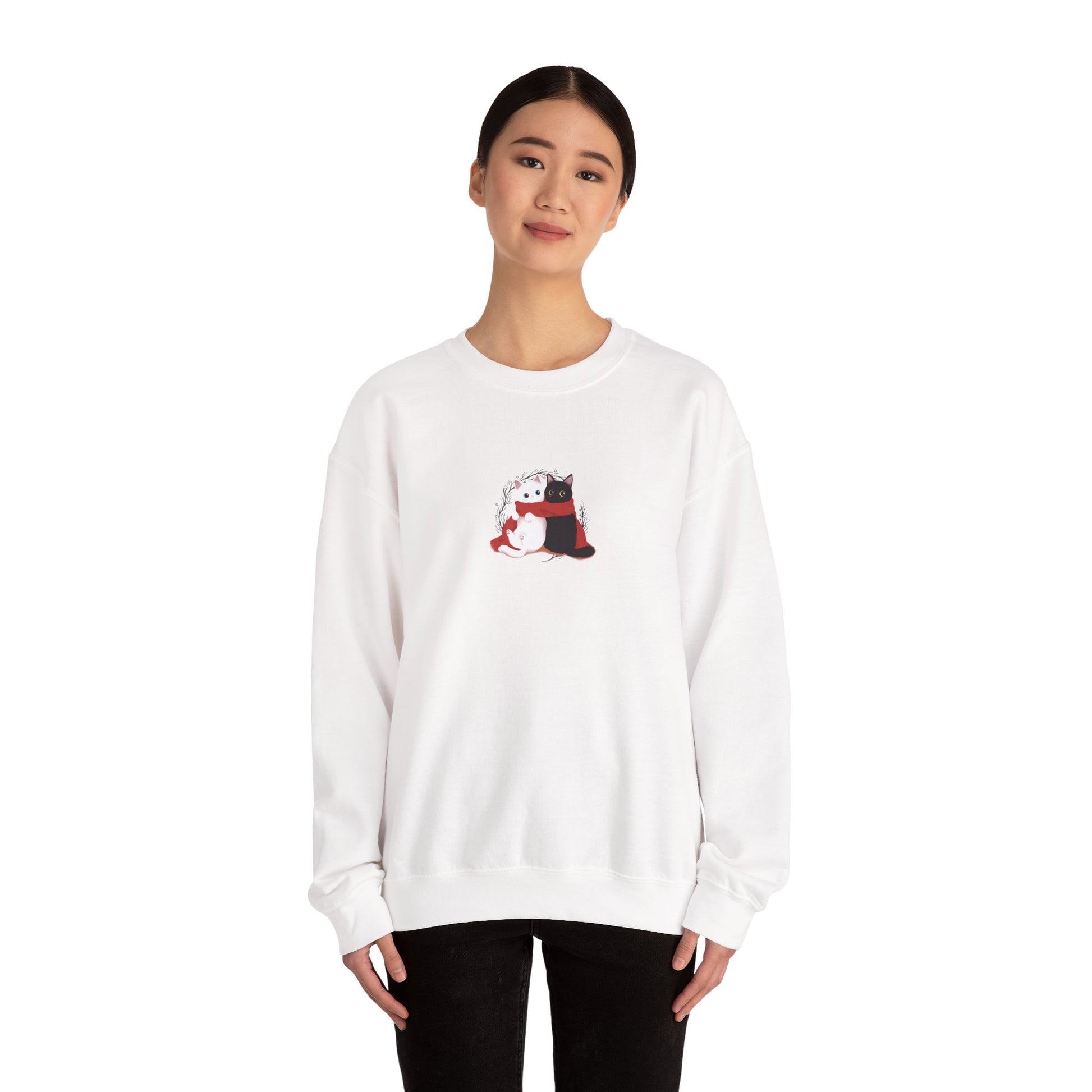 Person wearing a white sweatshirt with a small graphic on a white background