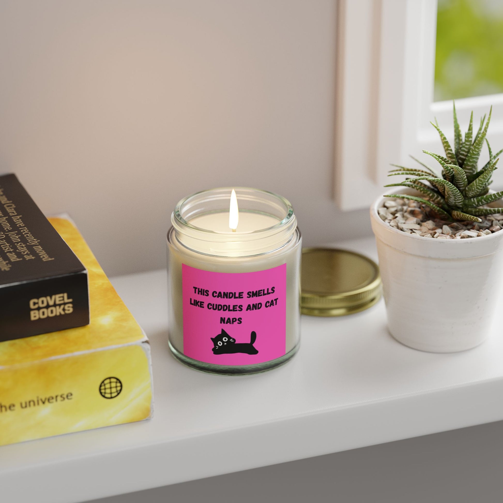 pink labelled candle with cuddles and cat nap text