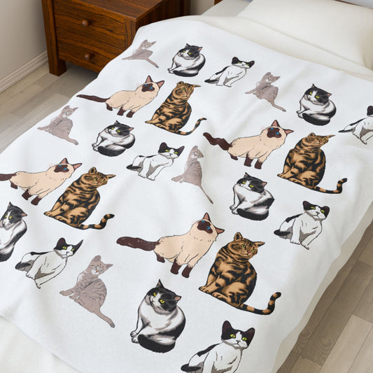 Bedspread with cat pattern on a bed in a bedroom setting