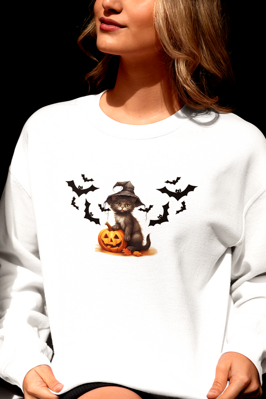 Person wearing a white sweatshirt with a Halloween design featuring a dog, pumpkins, and bats.