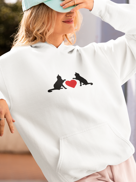 Person wearing a white hoodie with dog graphics and a heart symbol.