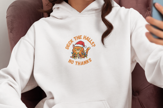 Person wearing a white hoodie with a graphic design, sitting in a chair and taking a selfie.