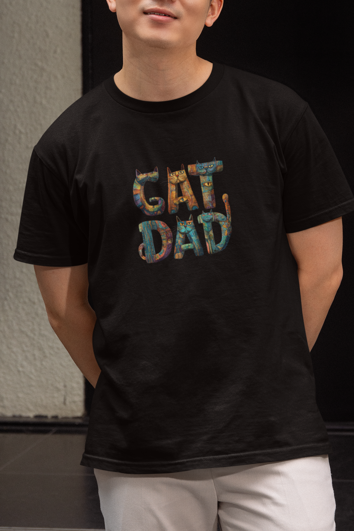 Person wearing a black t-shirt with 'CAT DAD' text standing in front of a building entrance.