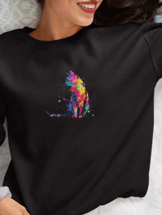 Person wearing a black sweatshirt with a colorful cat design on a white surface