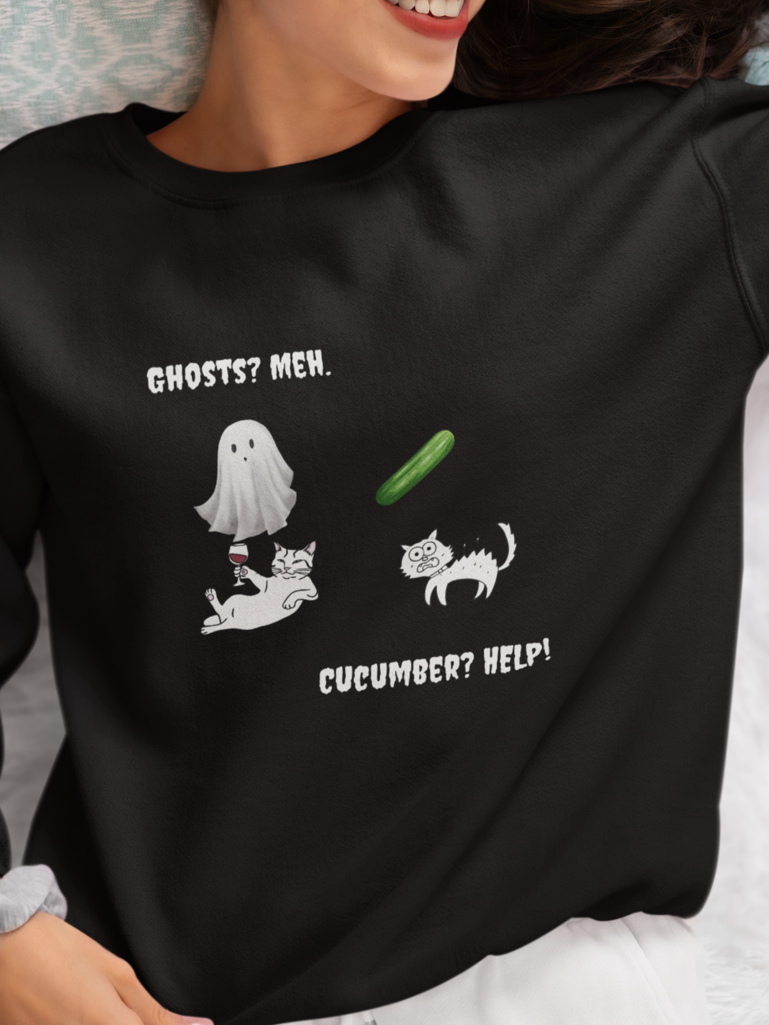 Person wearing a black sweatshirt with a humorous graphic and text.
