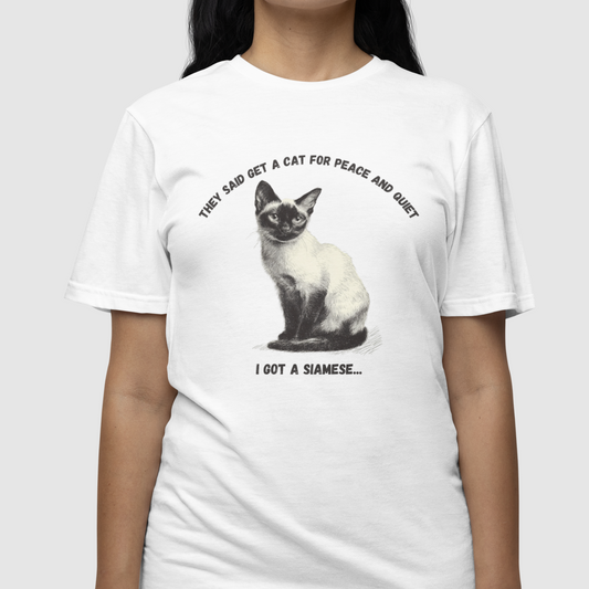 Person wearing a white t-shirt with a Siamese cat graphic and text.