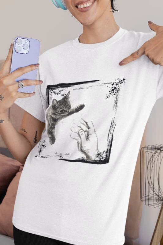 Person wearing a white t-shirt with a black and white graphic design, standing in a bedroom.