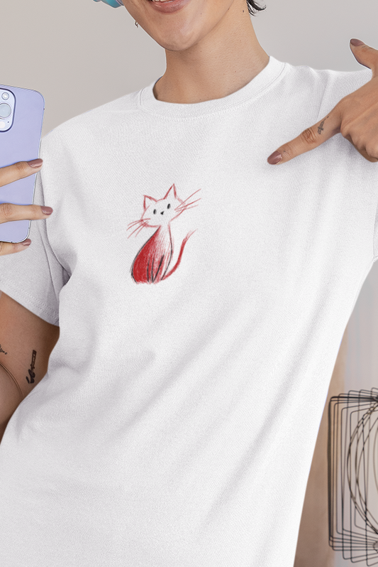 Woman wearing a white t-shirt with a red and black design, holding a phone in a bedroom.