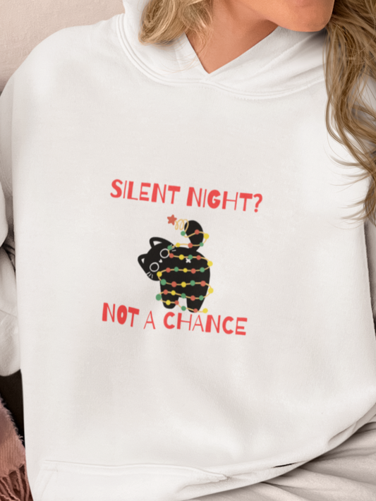 Person wearing a white hoodie with a Christmas-themed design sitting on a couch.