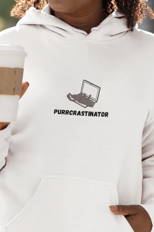 Woman wearing a white hoodie with a logo and text, holding a coffee cup outdoors.