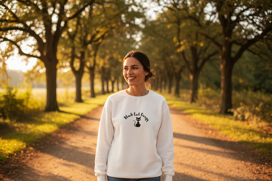 Person wearing Black Cat Energy sweater on outdoor walk