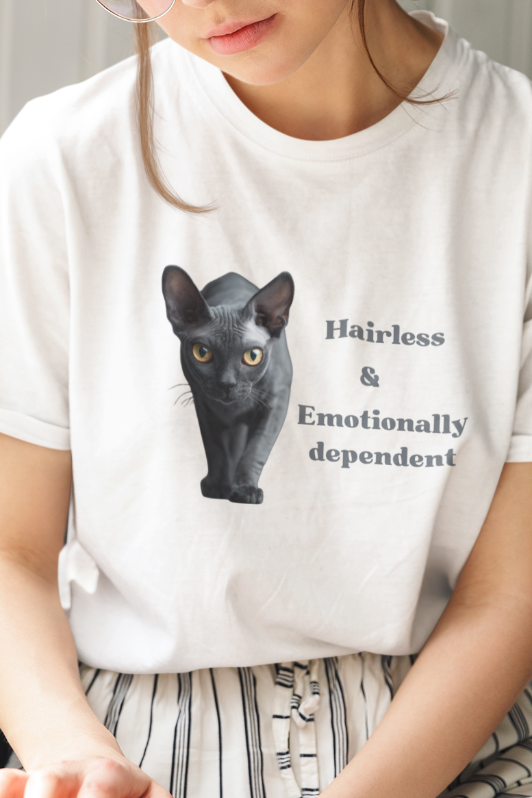 Woman reading a book wearing a white t-shirt with a black cat graphic and text.