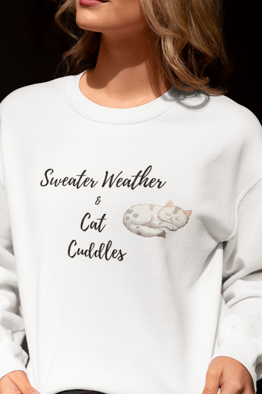 Person wearing a white sweatshirt with text and a cat illustration.