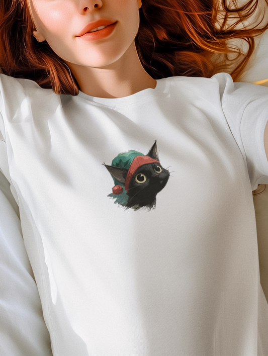 Woman wearing a white t-shirt with a black cat design, lying on a white bed.