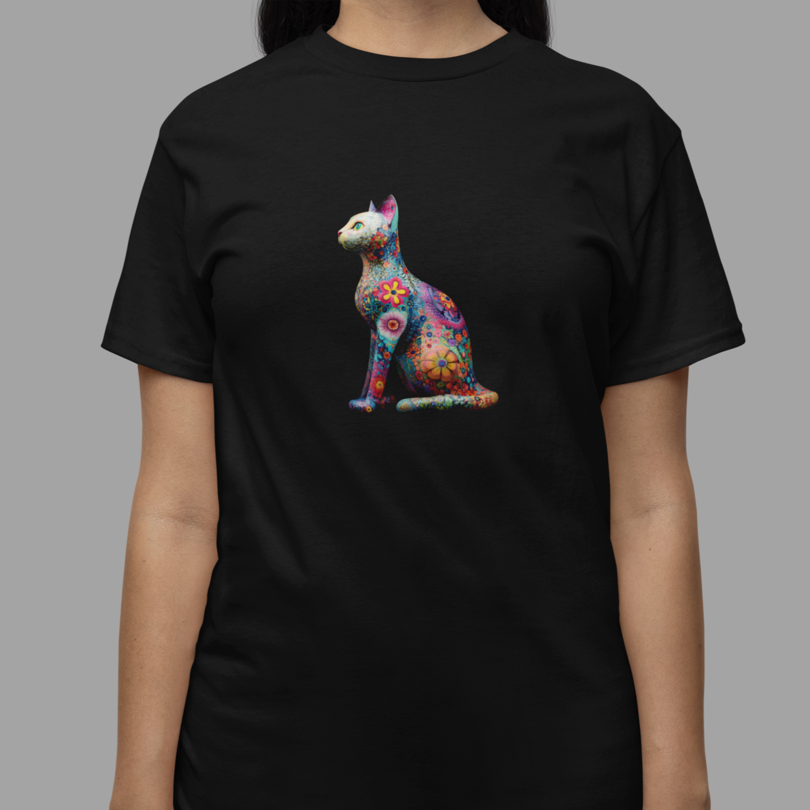 Black t-shirt with a colorful cat graphic worn by a person on a gray background